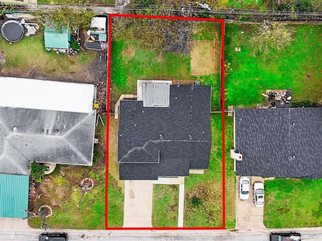an aerial view of a house with a yard and a fountain