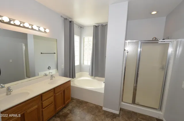 a bathroom with a double vanity sink and a mirror