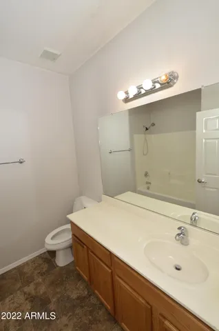 a bathroom with a sink mirror and toilet