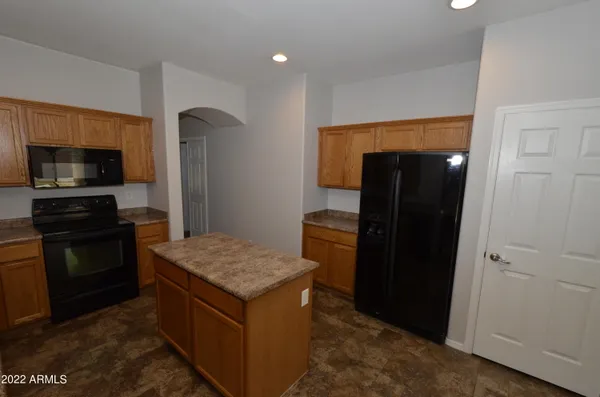 a kitchen with a stove and a refrigerator