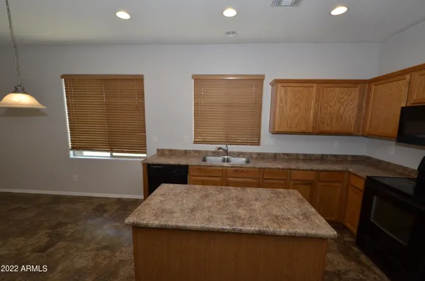 a kitchen with sink a window and cabinets