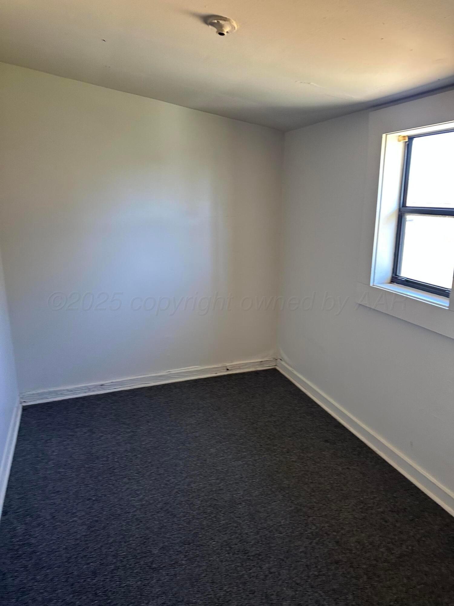 1021 Jackson Street Borger, TX 79007 - Photo 14 of 26 an empty room with a window