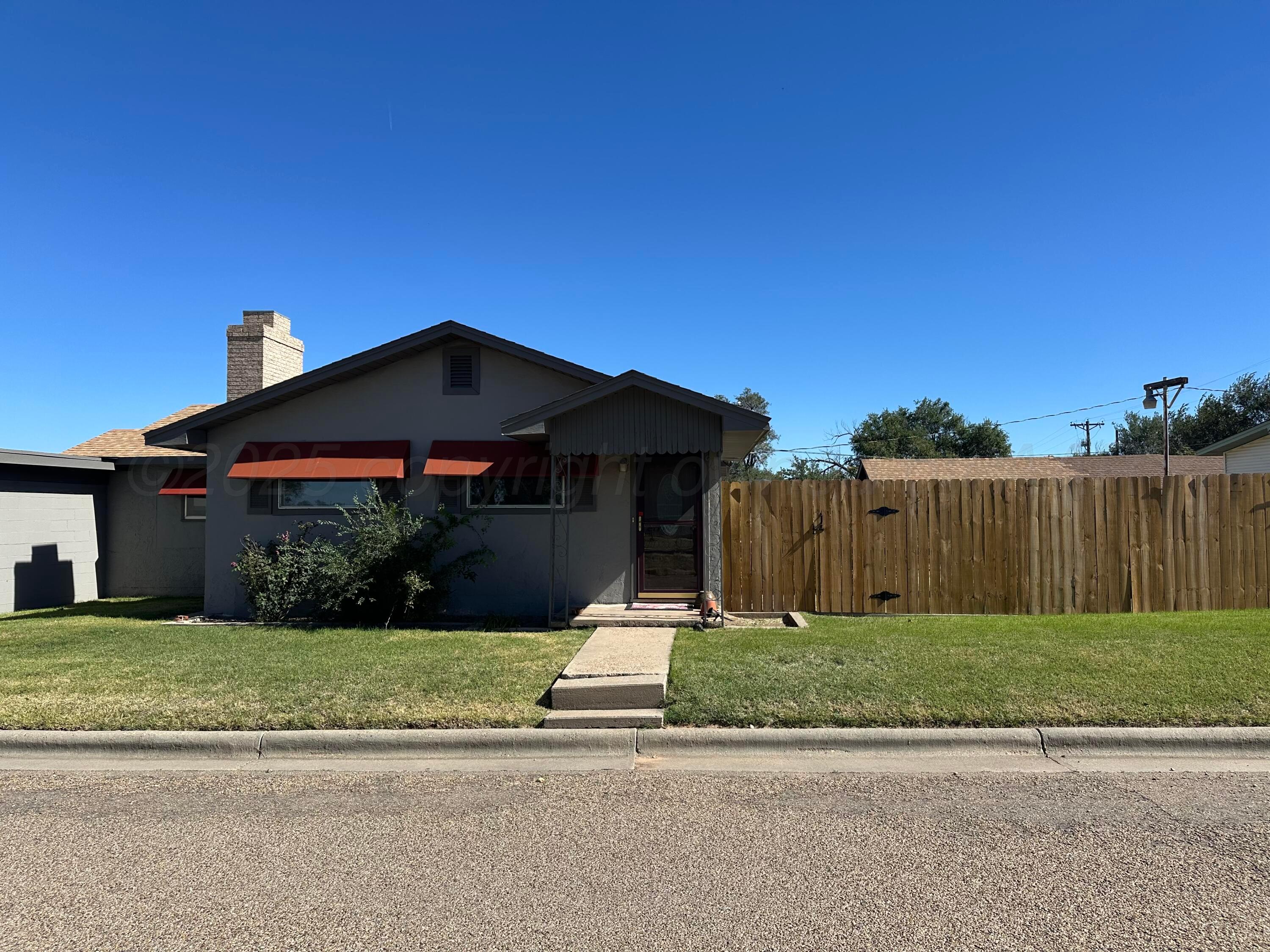 1021 Jackson Street Borger, TX 79007 - Photo 2 of 26 a front view of a house with a yard
