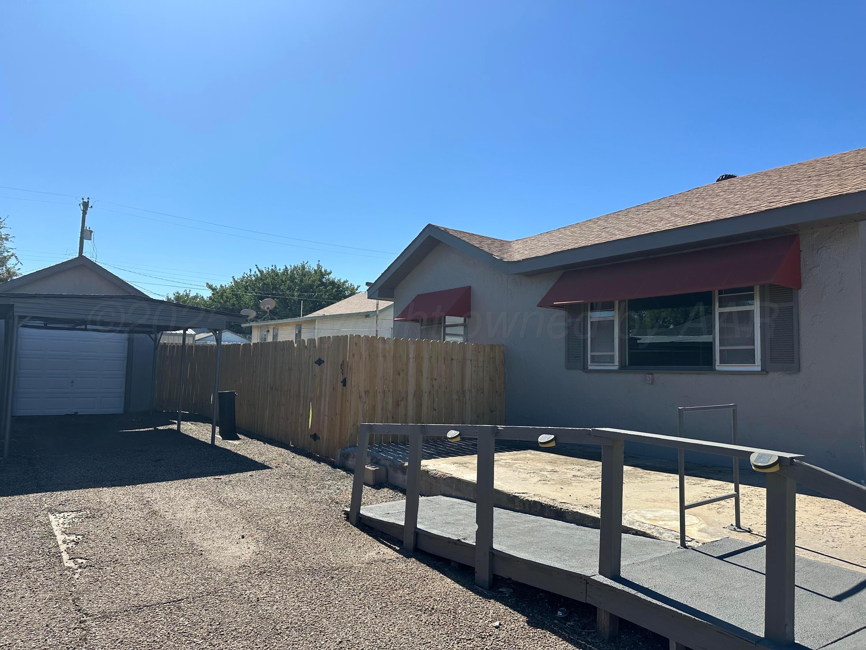 1021 Jackson Street Borger, TX 79007 - Photo 5 of 26 a view of backyard with deck and wooden fence