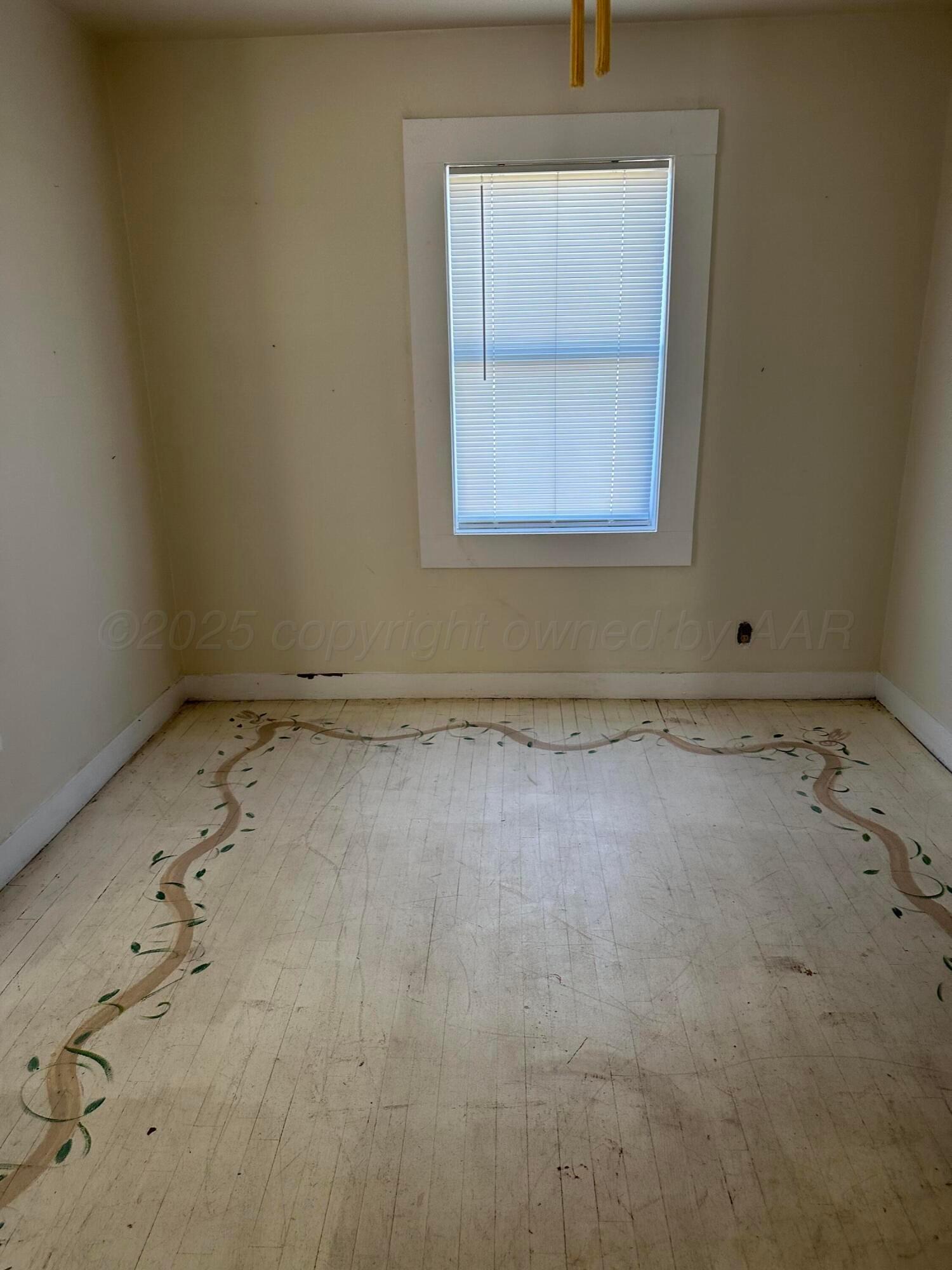 1021 Jackson Street Borger, TX 79007 - Photo 9 of 26 an empty room with a window