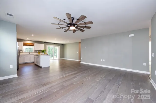 a view of a kitchen with a sink stainless steel appliances and cabinets