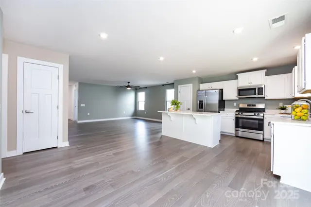 a view of kitchen with microwave and refrigerator