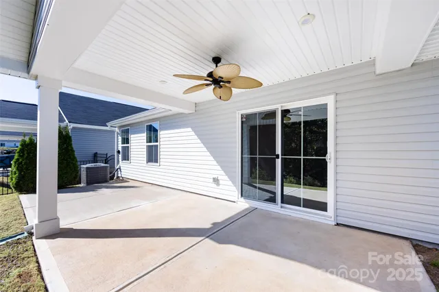 a view of a livingroom with a ceiling fan and window