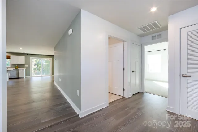 a view of a hallway with wooden floor