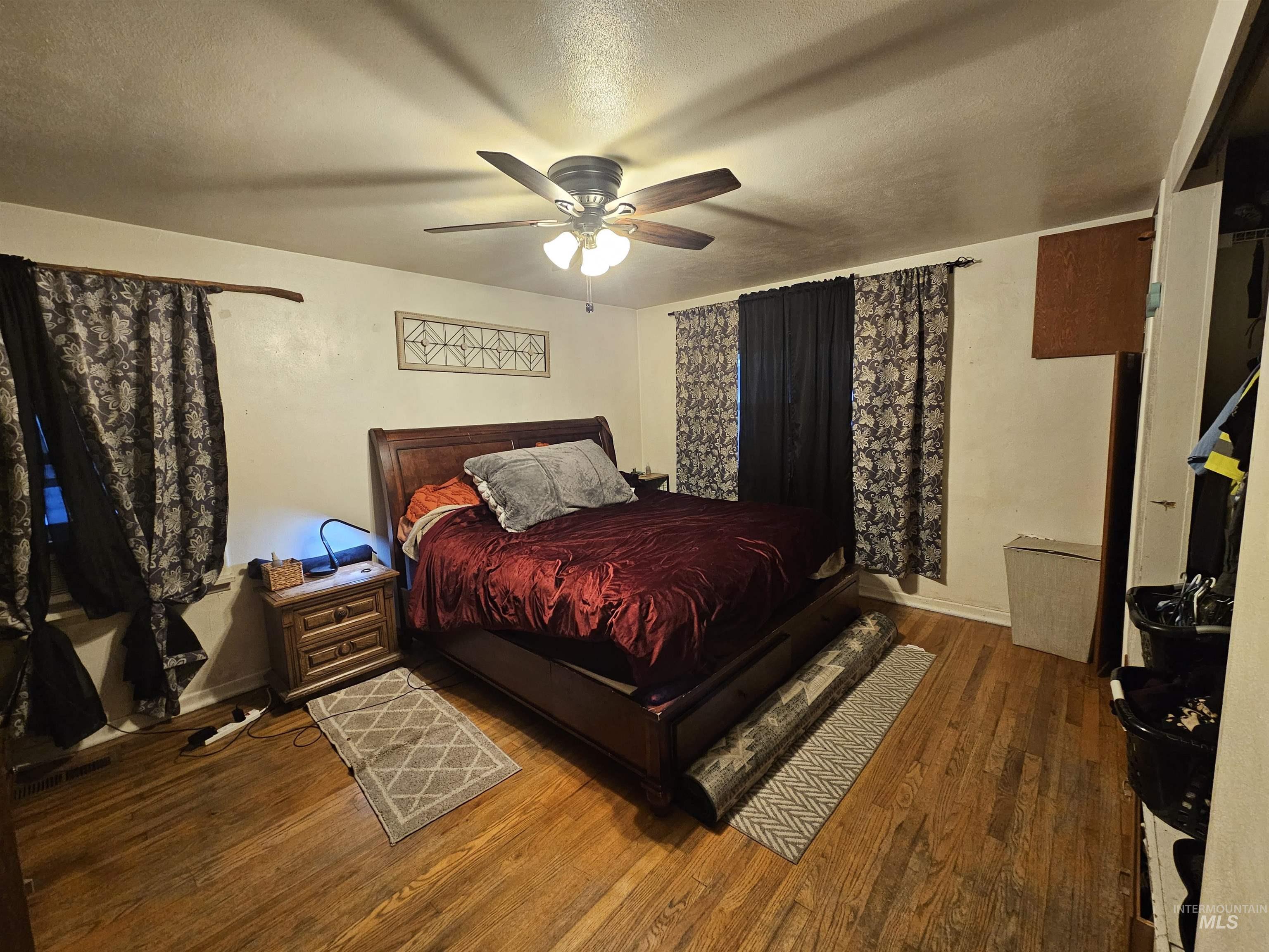 616 12th Street Clarkston, WA 99403 - Photo 11 of 24 Bedroom with a textured ceiling, wood finished floors, and a ceiling fan
