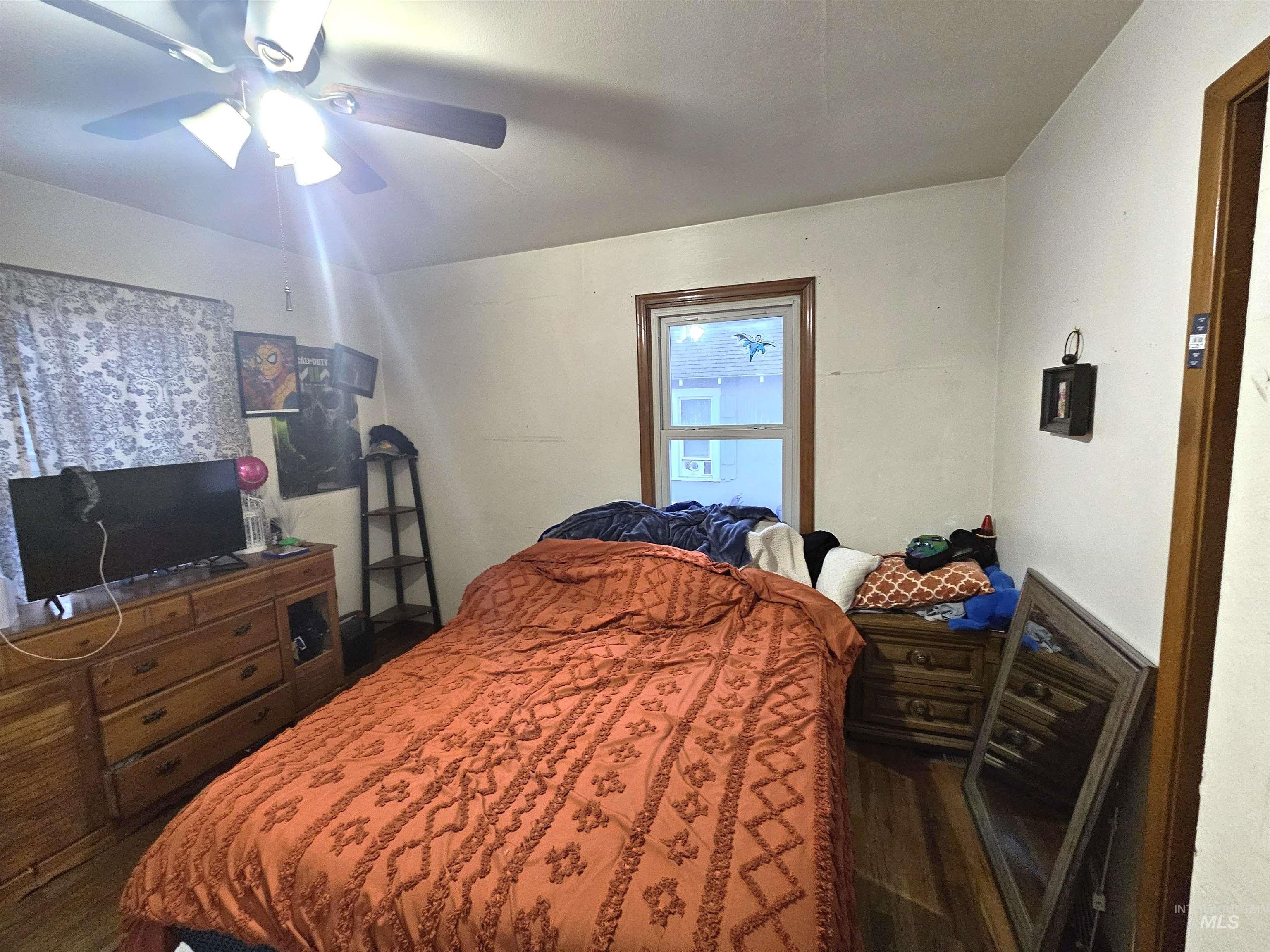 616 12th Street Clarkston, WA 99403 - Photo 13 of 24 Bedroom featuring a ceiling fan and wood finished floors