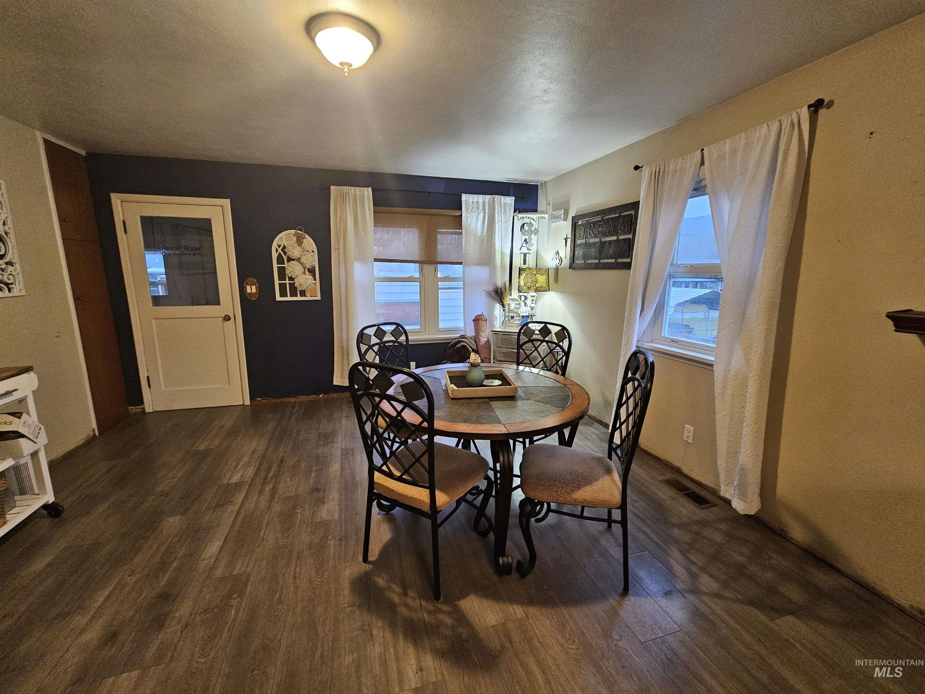 616 12th Street Clarkston, WA 99403 - Photo 6 of 24 Dining area with healthy amount of natural light, dark wood-type flooring, and a textured ceiling