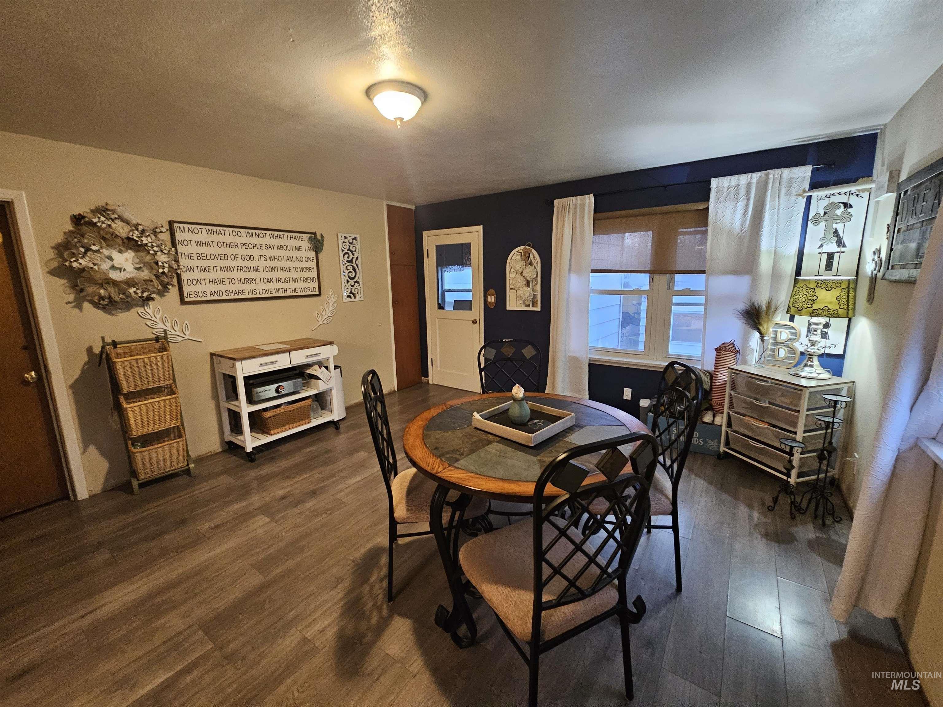 616 12th Street Clarkston, WA 99403 - Photo 7 of 24 Dining area featuring a textured ceiling and dark wood-style floors