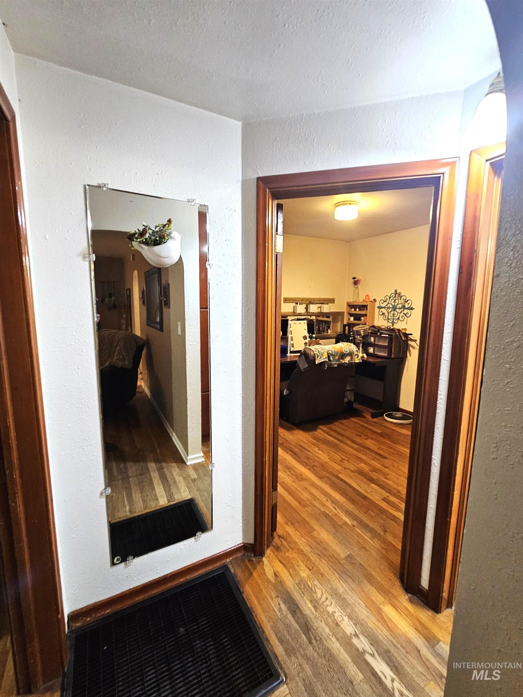 616 12th Street Clarkston, WA 99403 - Photo 8 of 24 Hall with a textured wall, wood finished floors, and arched walkways