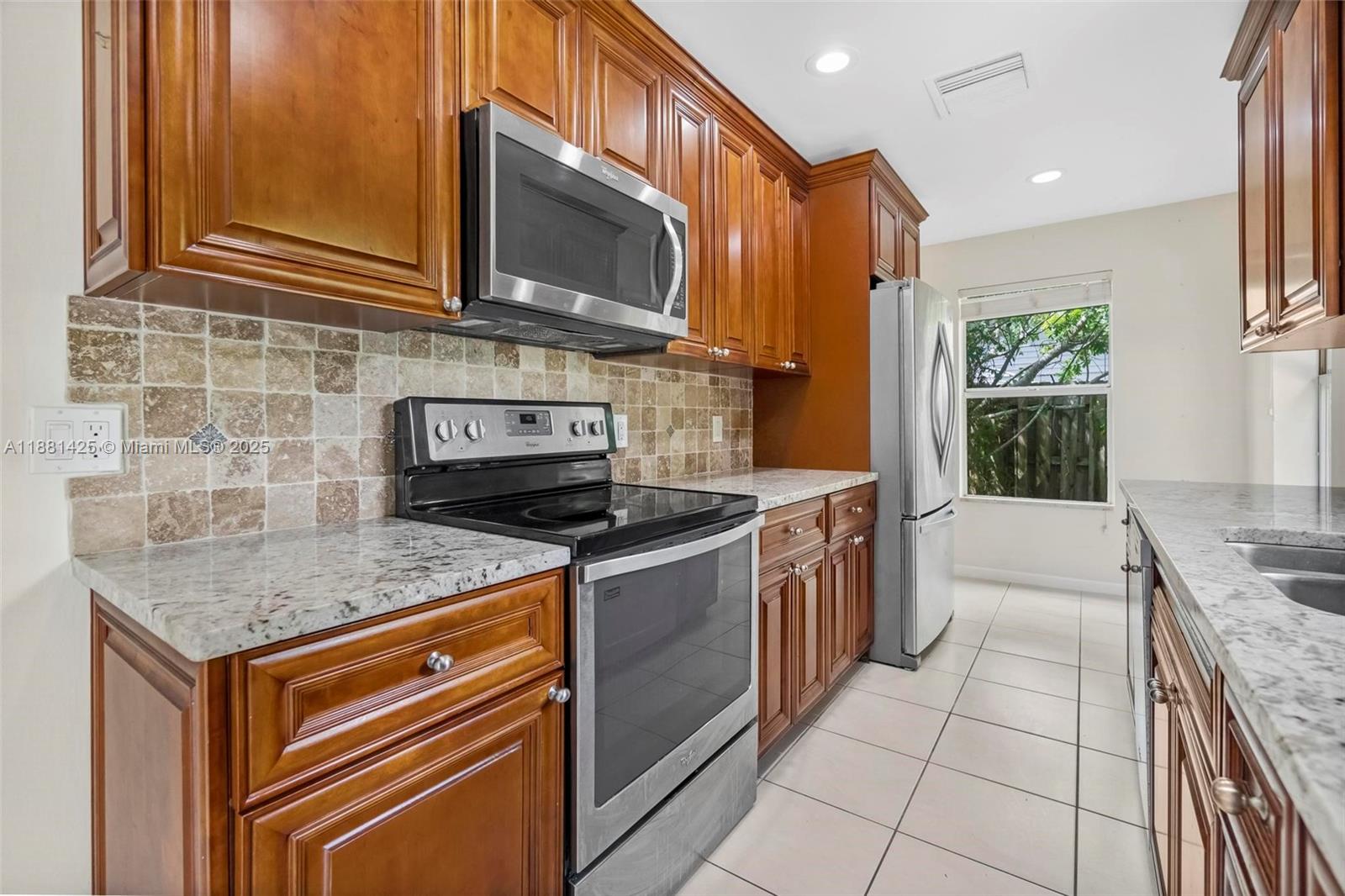5119 Oak Hill Road Delray Beach, FL 33484 - Photo 11 of 48 a kitchen with a stove sink and microwave