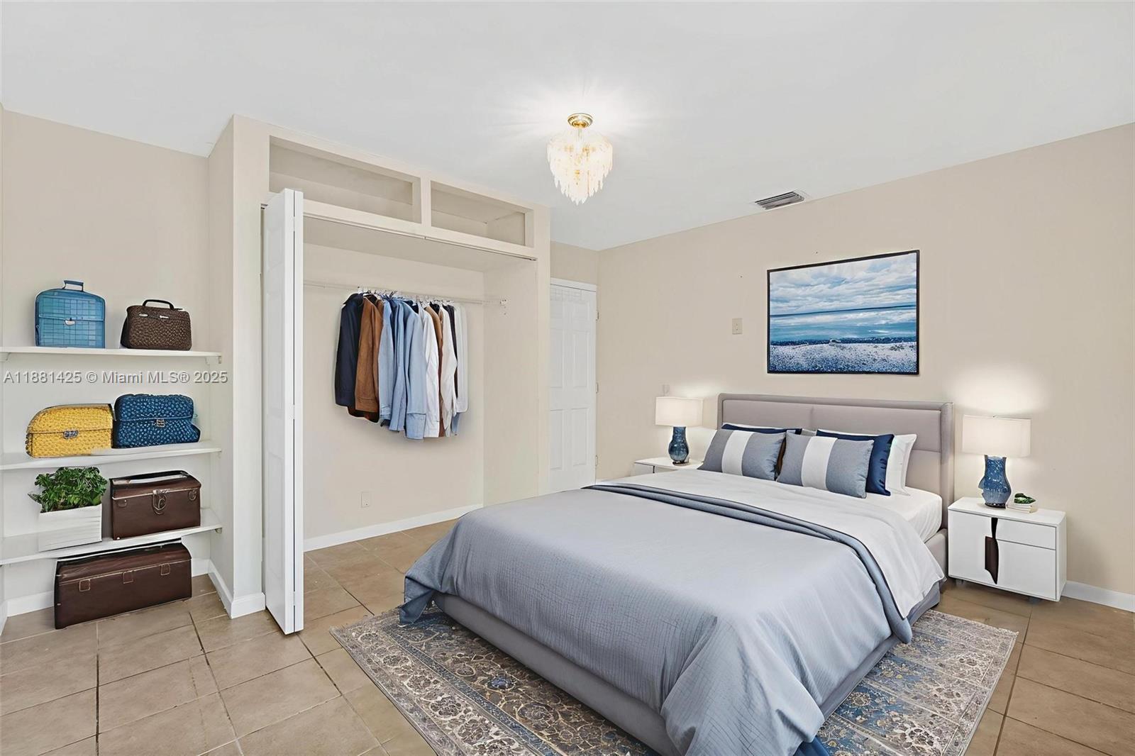 5119 Oak Hill Road Delray Beach, FL 33484 - Photo 17 of 48 a bedroom with a bed a couch and a window