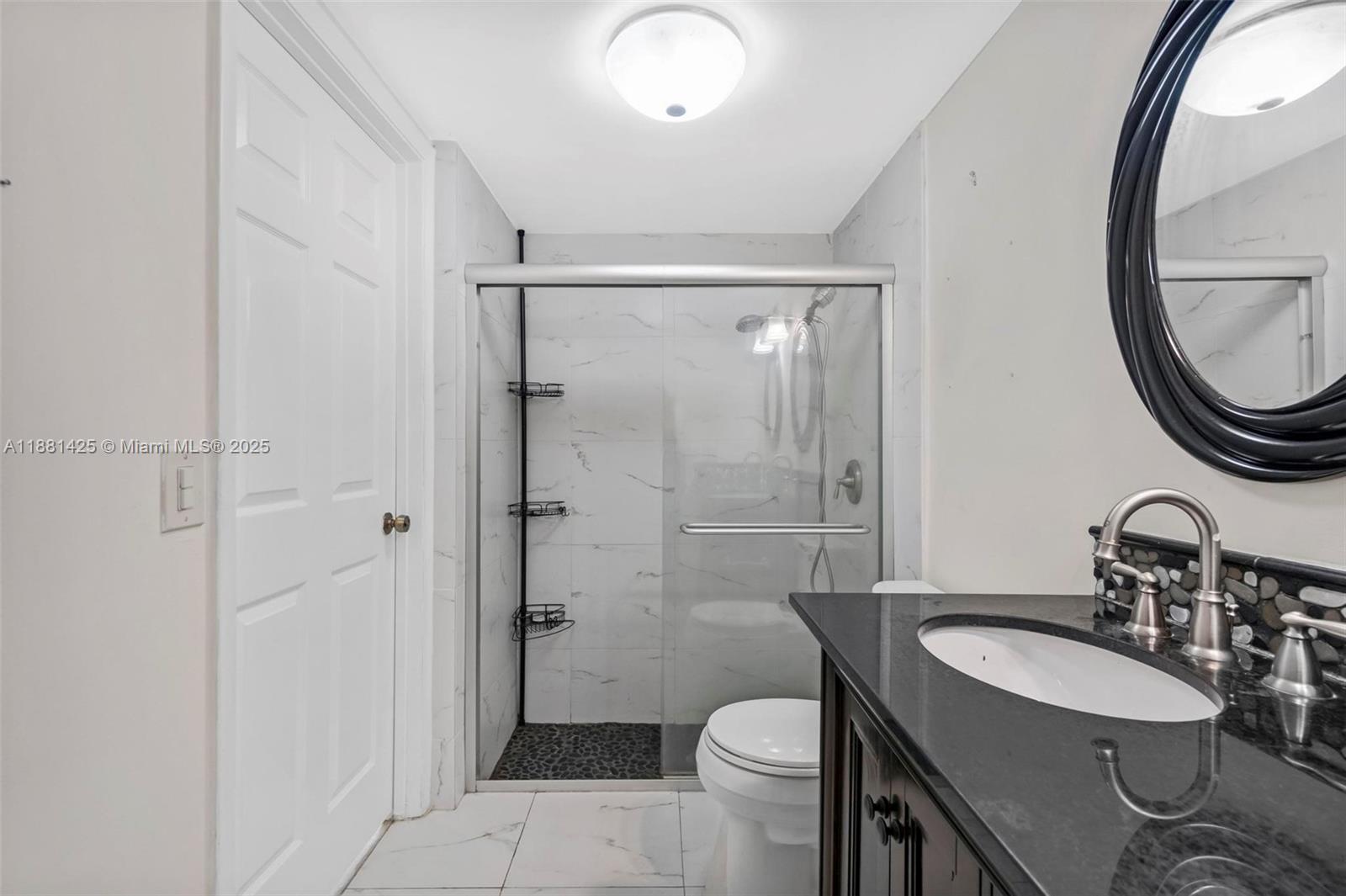 5119 Oak Hill Road Delray Beach, FL 33484 - Photo 23 of 48 a bathroom with a sink toilet a mirror and shower