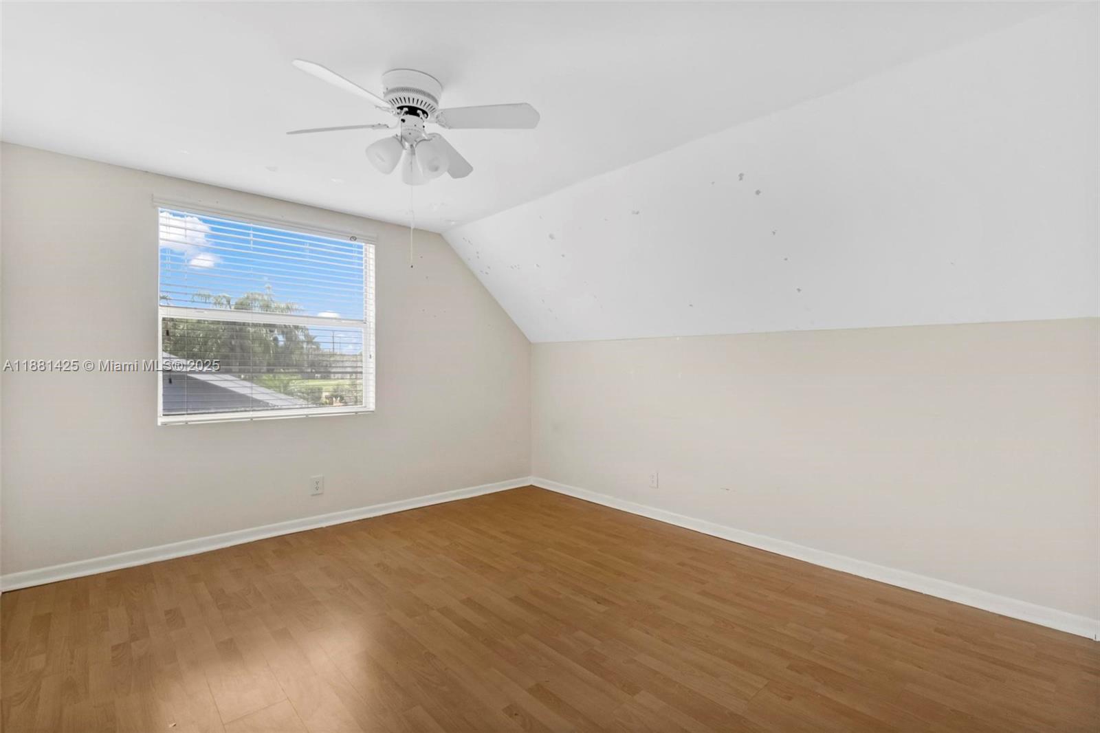 5119 Oak Hill Road Delray Beach, FL 33484 - Photo 27 of 48 an empty room with a window and a ceiling fan