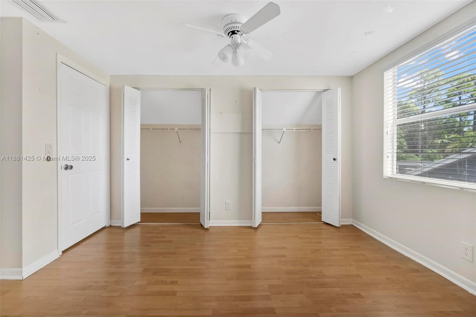 5119 Oak Hill Road Delray Beach, FL 33484 - Photo 28 of 48 wooden floor in an empty room with a window