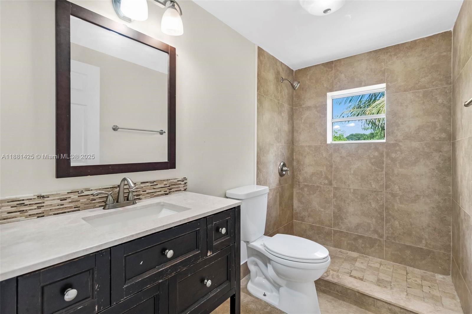 5119 Oak Hill Road Delray Beach, FL 33484 - Photo 29 of 48 a bathroom with a sink a toilet a mirror and shower