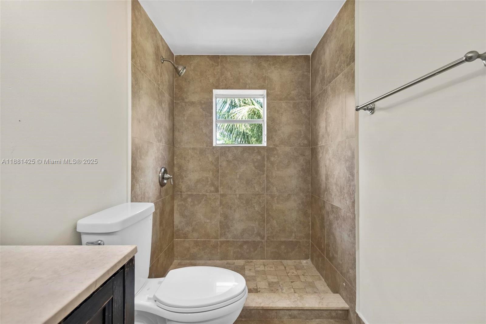 5119 Oak Hill Road Delray Beach, FL 33484 - Photo 30 of 48 a bathroom with a toilet a sink and a shower