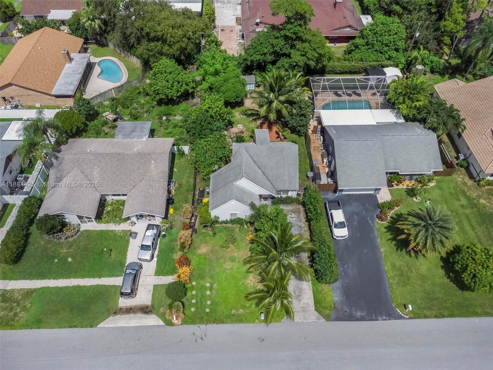 5119 Oak Hill Road Delray Beach, FL 33484 - Photo 3 of 48 an aerial view of a house with a garden and plants