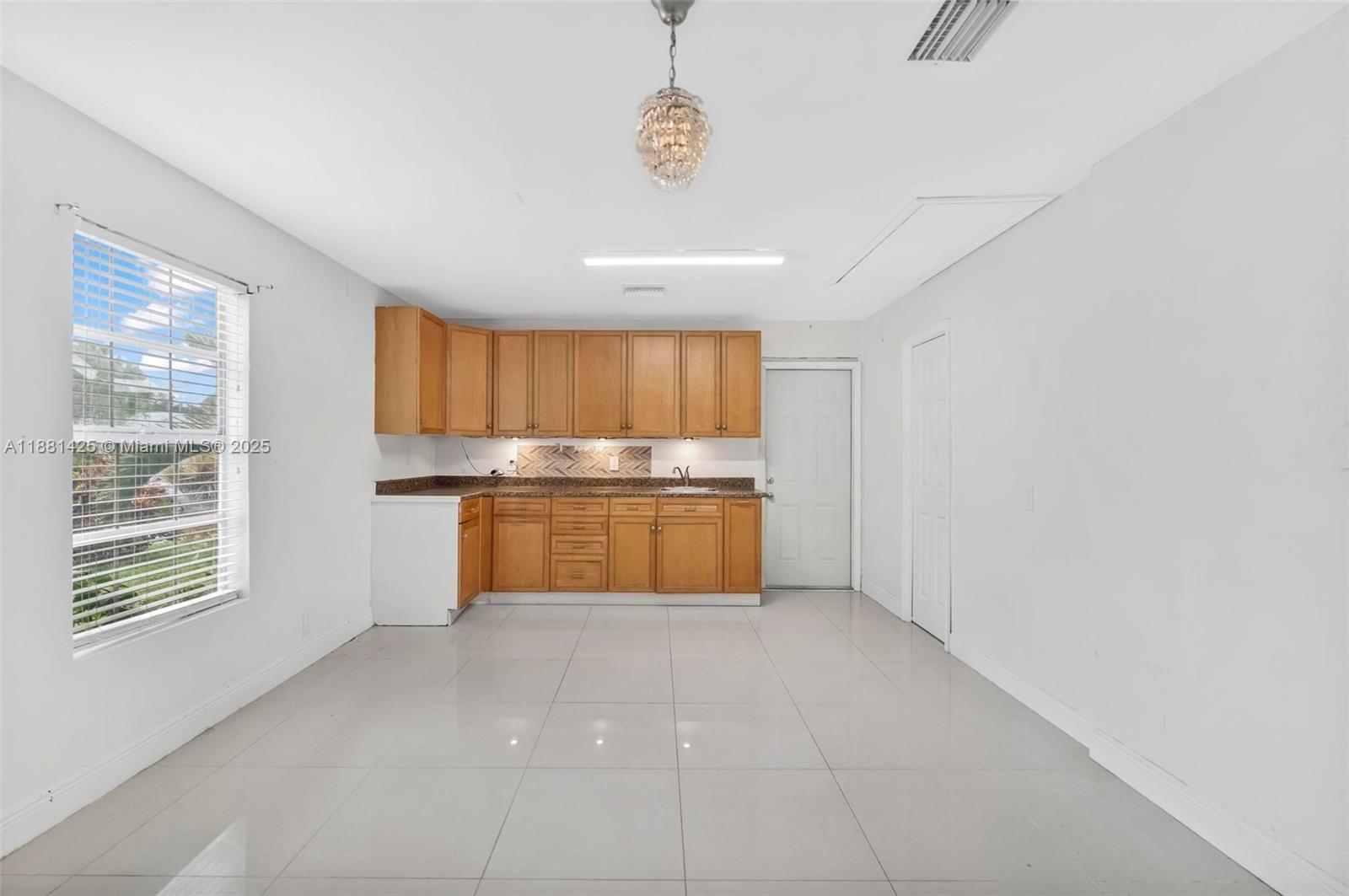 5119 Oak Hill Road Delray Beach, FL 33484 - Photo 31 of 48 a kitchen with stainless steel appliances granite countertop a stove a sink and a refrigerator