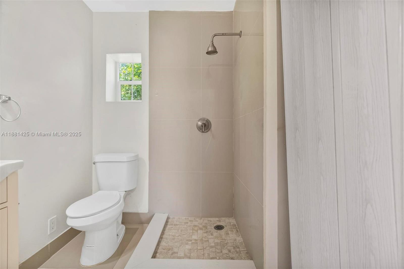 5119 Oak Hill Road Delray Beach, FL 33484 - Photo 34 of 48 a bathroom with a toilet and a shower