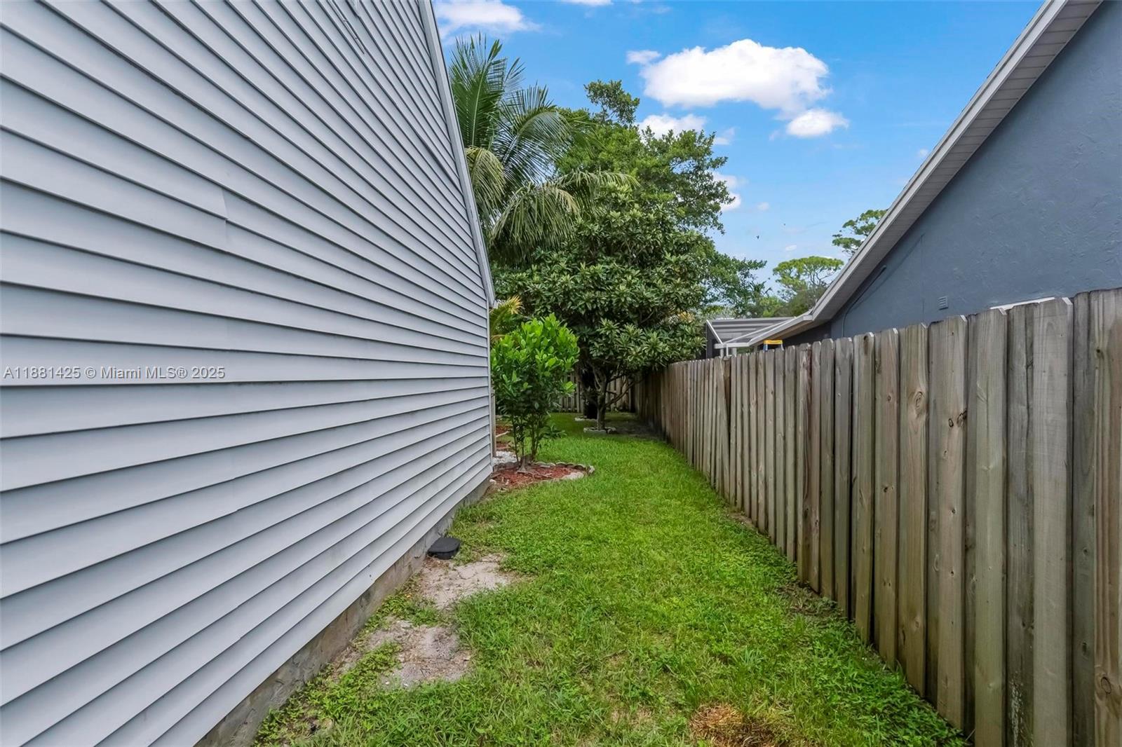 5119 Oak Hill Road Delray Beach, FL 33484 - Photo 37 of 48 a view of a backyard with wooden fence