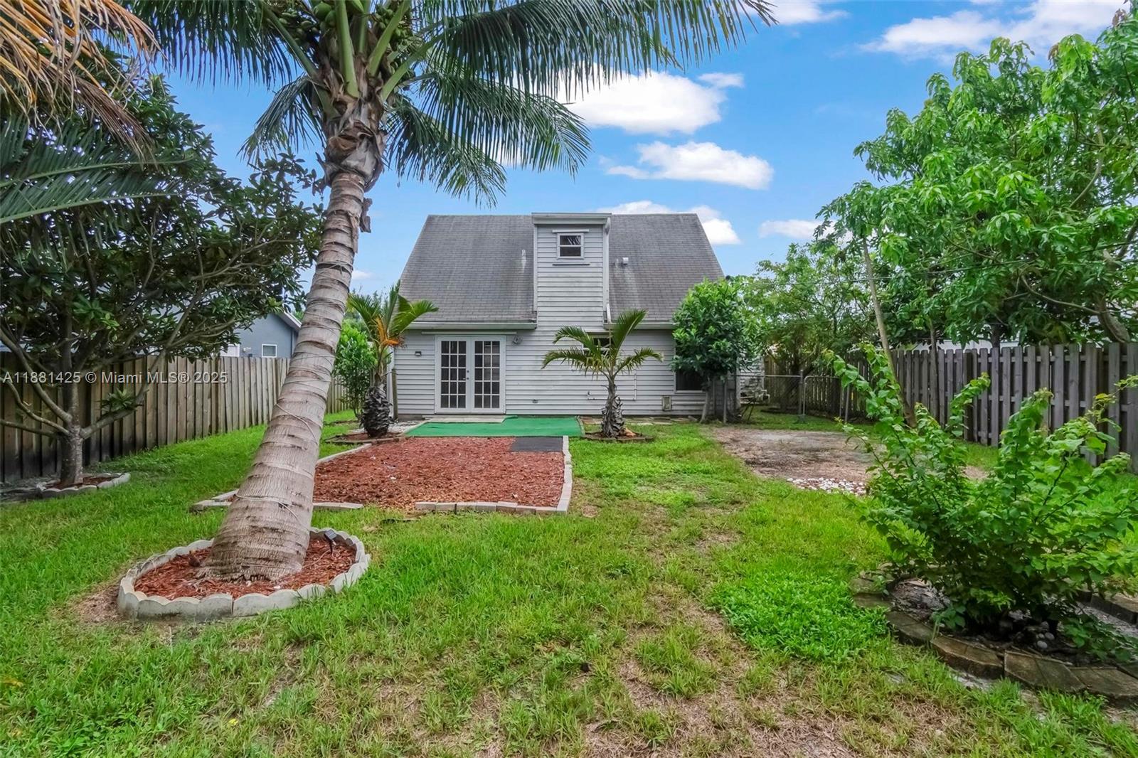 5119 Oak Hill Road Delray Beach, FL 33484 - Photo 39 of 48 a front view of a house with garden