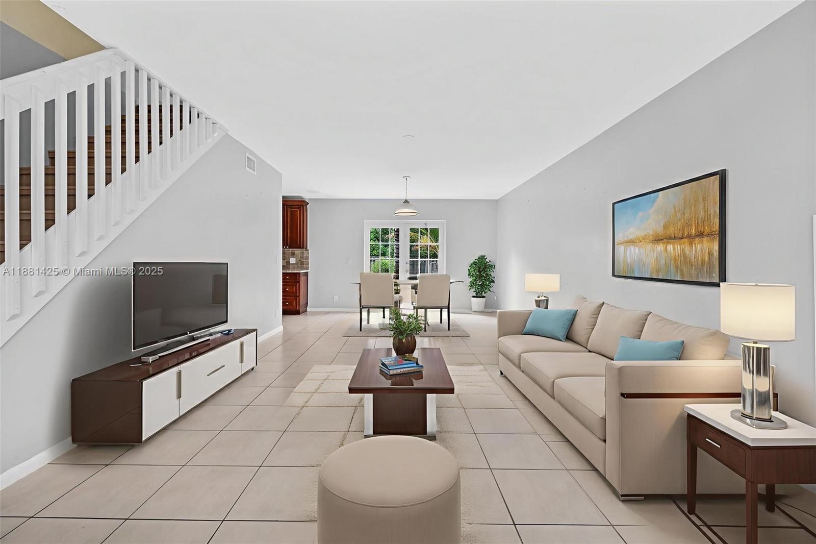 5119 Oak Hill Road Delray Beach, FL 33484 - Photo 6 of 48 a living room with furniture a flat screen tv and a flat screen tv