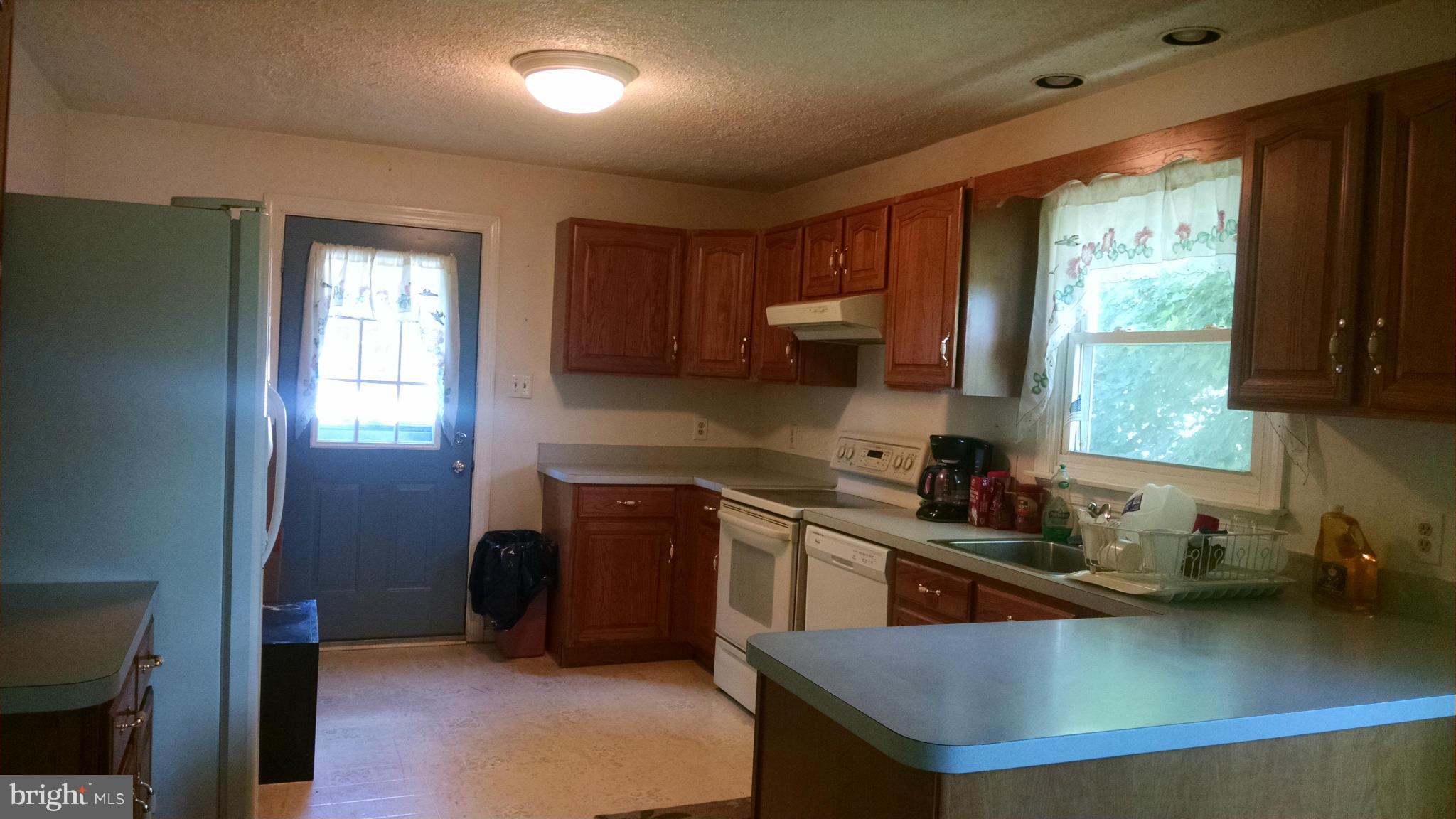 1091 Lower Pindell Road Lothian, MD 20711 - Photo 4 of 26 a kitchen with a sink a window and cabinets