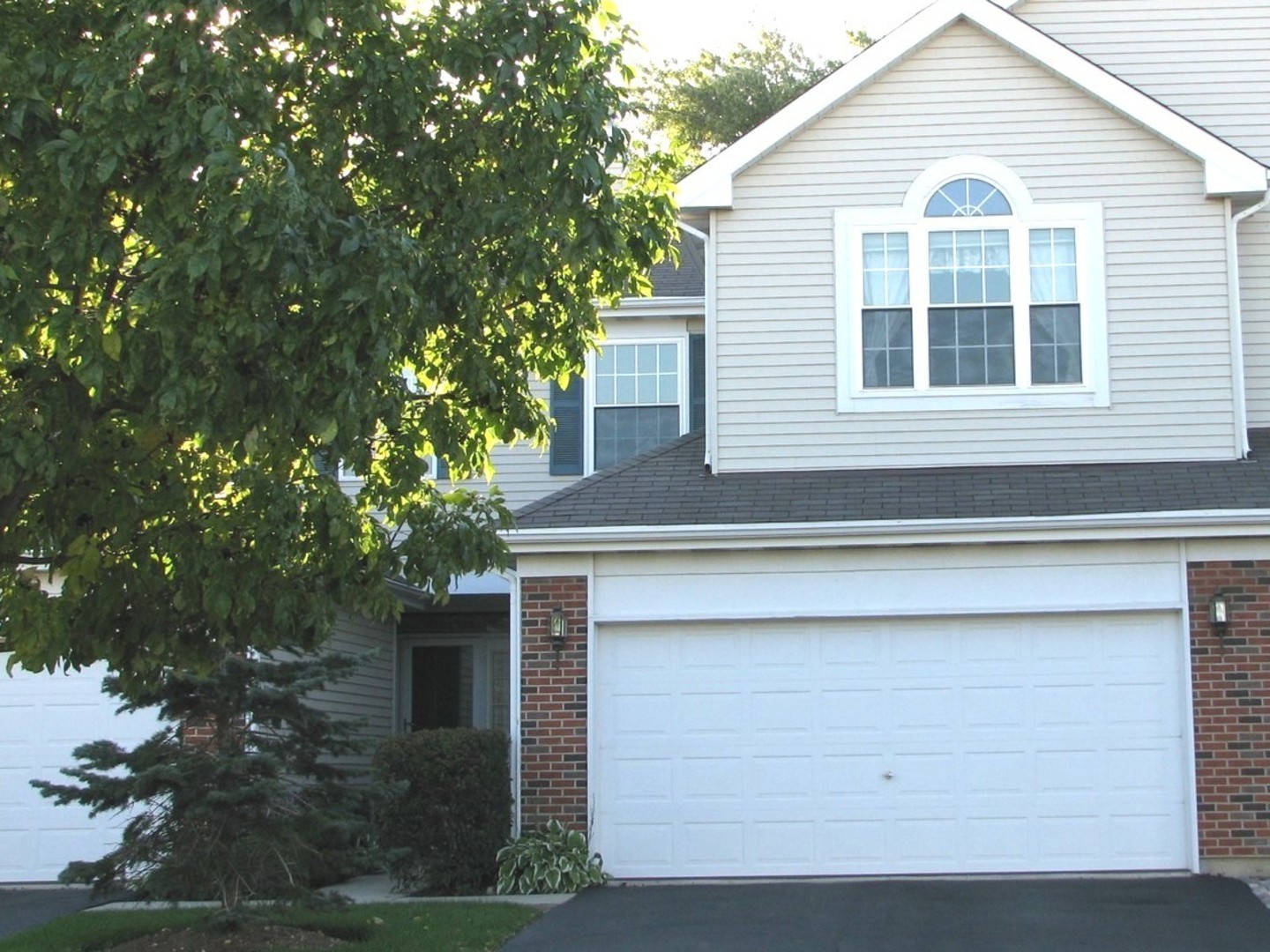 a front view of a house with a garage