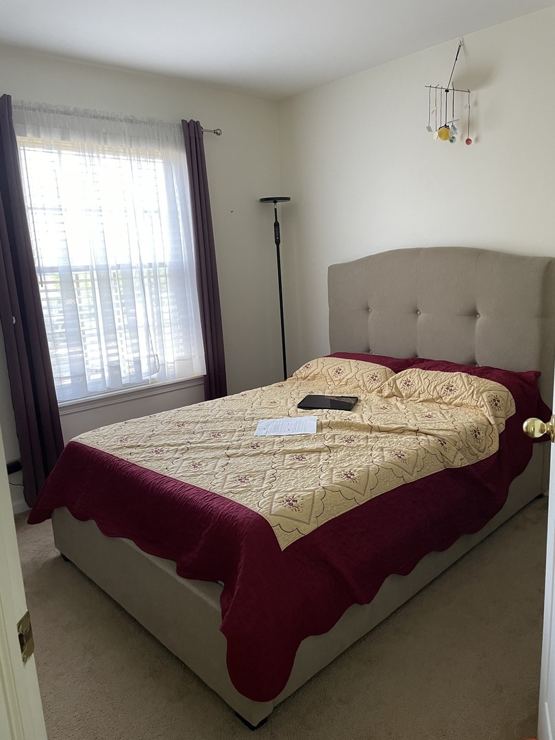 Undisclosed Address Hoffman Estates, IL 60169 - Photo 13 of 15 a bedroom with a bed and window