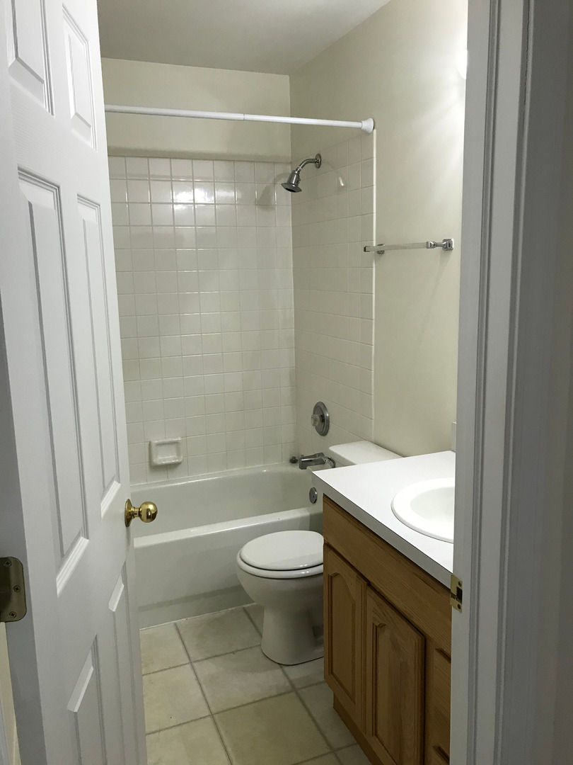 Undisclosed Address Hoffman Estates, IL 60169 - Photo 14 of 15 a bathroom with a granite countertop sink a toilet and shower