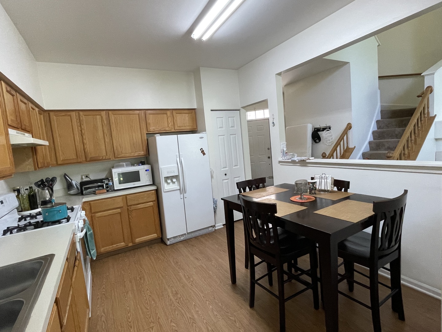 Undisclosed Address Hoffman Estates, IL 60169 - Photo 7 of 15 a kitchen with stainless steel appliances wooden floor dining table and chairs
