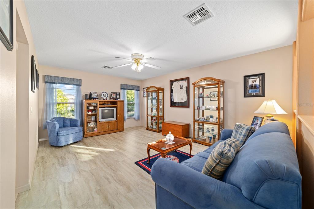 15680 Southwest 13th Circle Ocala, FL 34473 - Photo 22 of 75 a living room with furniture and a chandelier