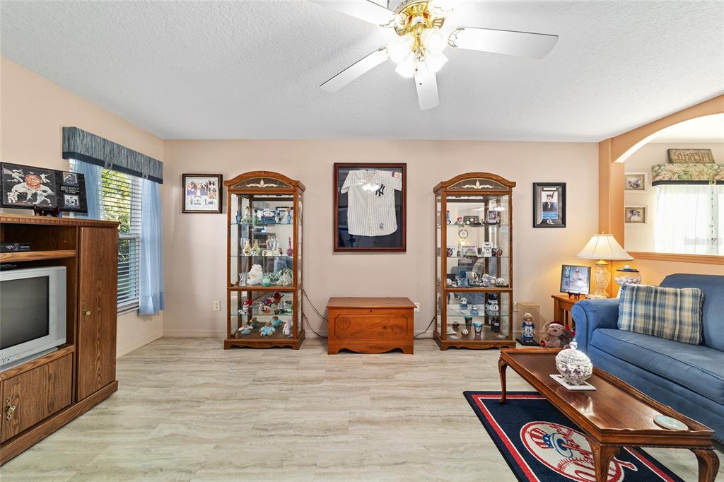 15680 Southwest 13th Circle Ocala, FL 34473 - Photo 23 of 75 a living room with furniture and a fireplace