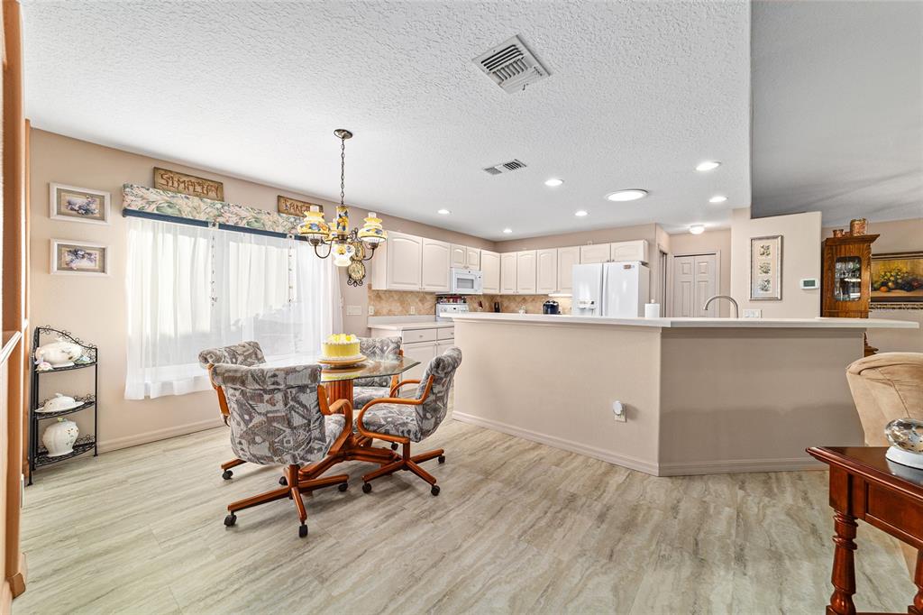 15680 Southwest 13th Circle Ocala, FL 34473 - Photo 27 of 75 a view of a dining room with furniture and chandelier