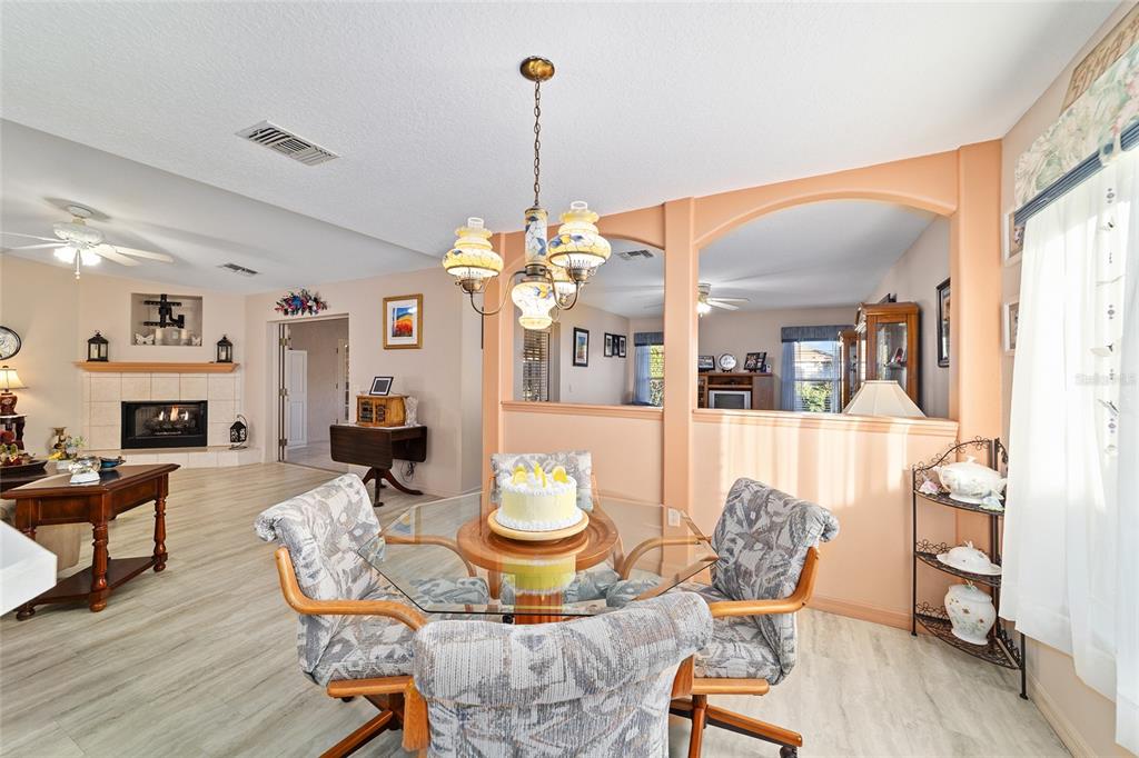 15680 Southwest 13th Circle Ocala, FL 34473 - Photo 29 of 75 a living room with furniture a dining table and a chandelier
