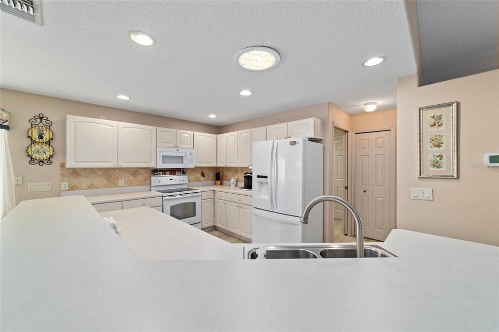 15680 Southwest 13th Circle Ocala, FL 34473 - Photo 30 of 74 a kitchen with stainless steel appliances granite countertop a refrigerator sink and cabinets