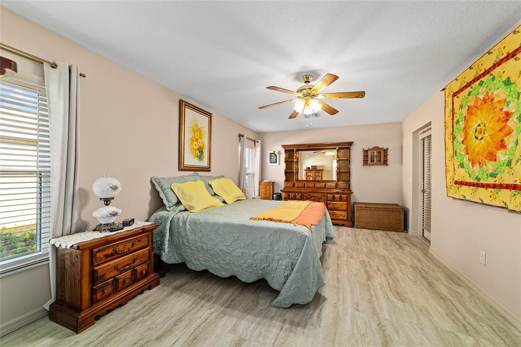 15680 Southwest 13th Circle Ocala, FL 34473 - Photo 48 of 75 a bedroom with a bed and wooden floor