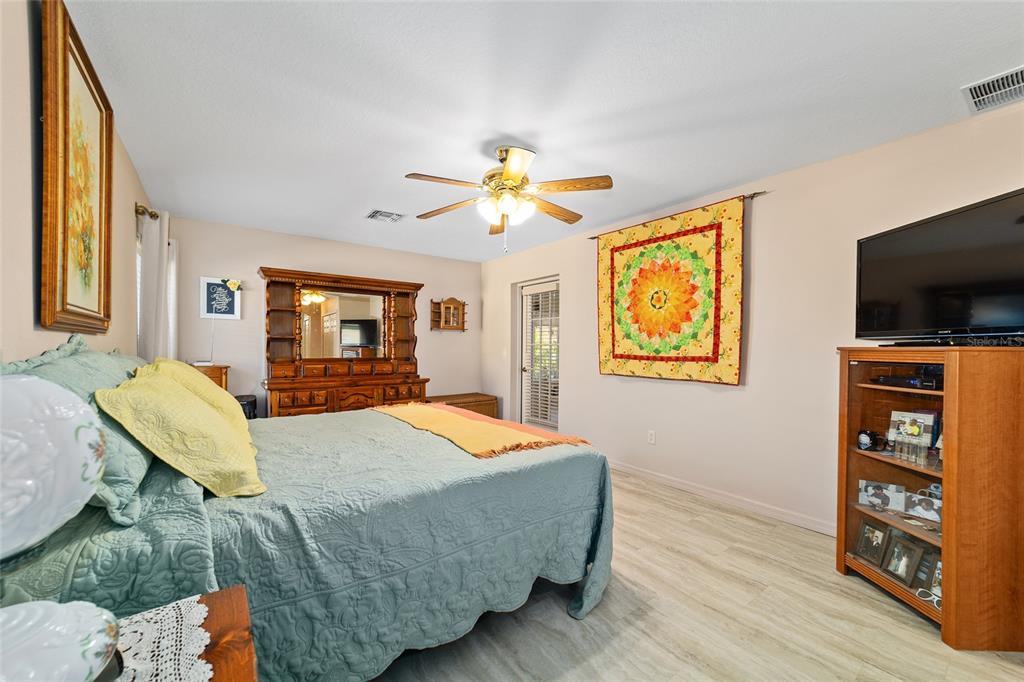 15680 Southwest 13th Circle Ocala, FL 34473 - Photo 49 of 75 a bed room with a bed and a television