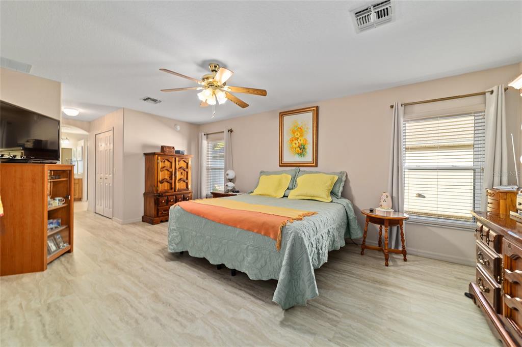 15680 Southwest 13th Circle Ocala, FL 34473 - Photo 50 of 74 a bedroom with a bed and a chandelier