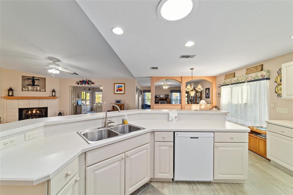 15680 Southwest 13th Circle Ocala, FL 34473 - Photo 56 of 75 a kitchen with granite countertop a sink and white cabinets