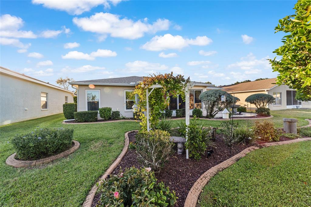 15680 Southwest 13th Circle Ocala, FL 34473 - Photo 72 of 75 a view of a garden with a house in the background