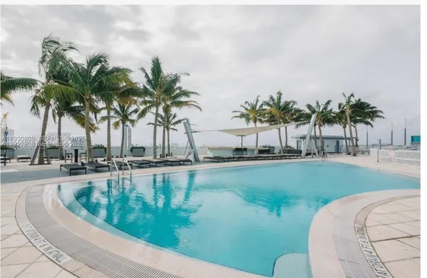 a view of swimming pool with a table and chairs