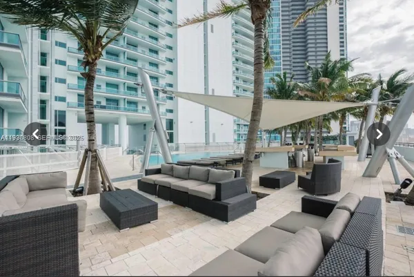 a view of the patio with couches and potted plants