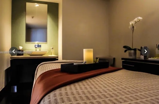 a bedroom with a bed and a lamp