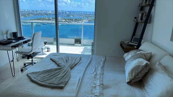 a living room with furniture and a floor to ceiling window